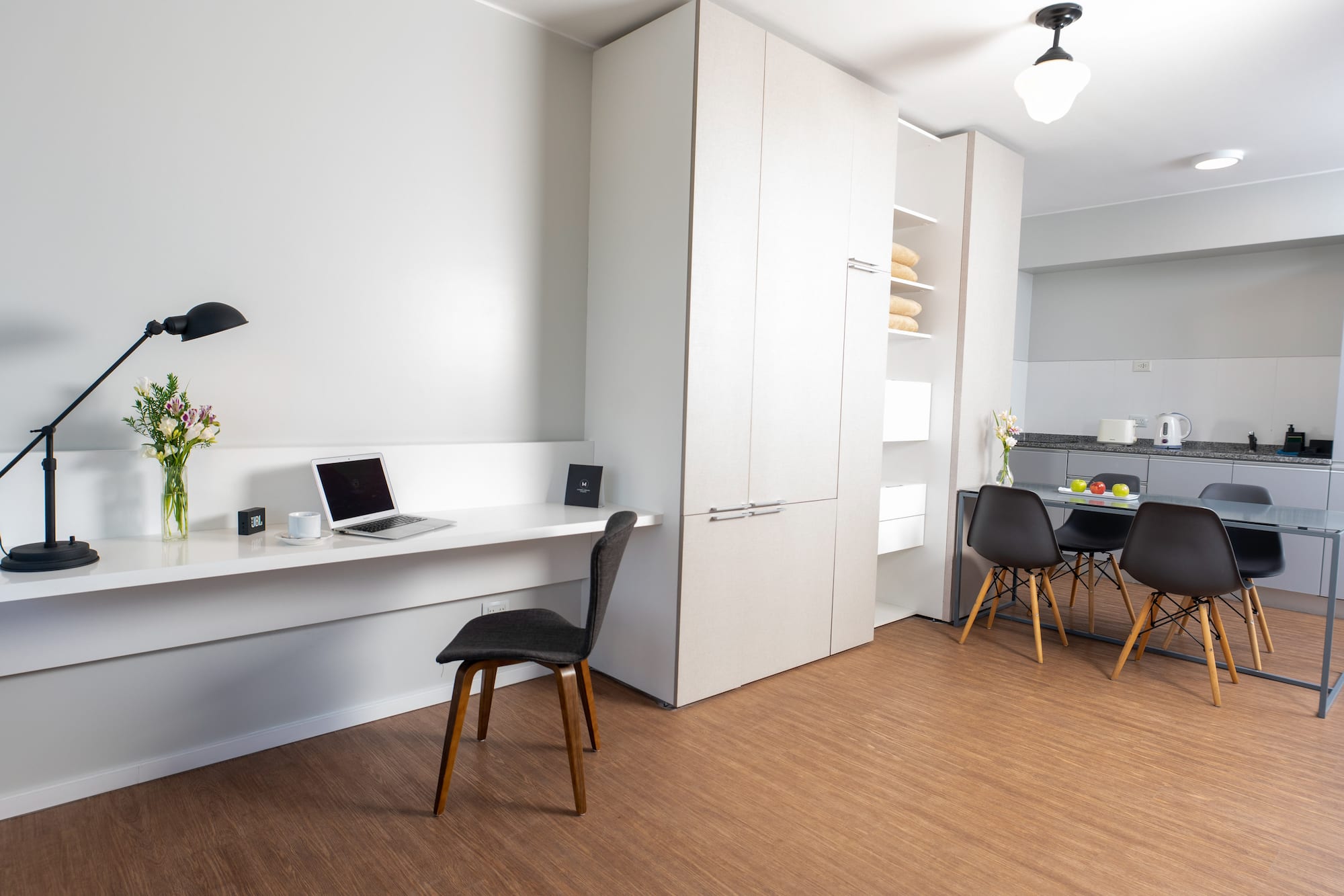 a room with a desk and a laptop