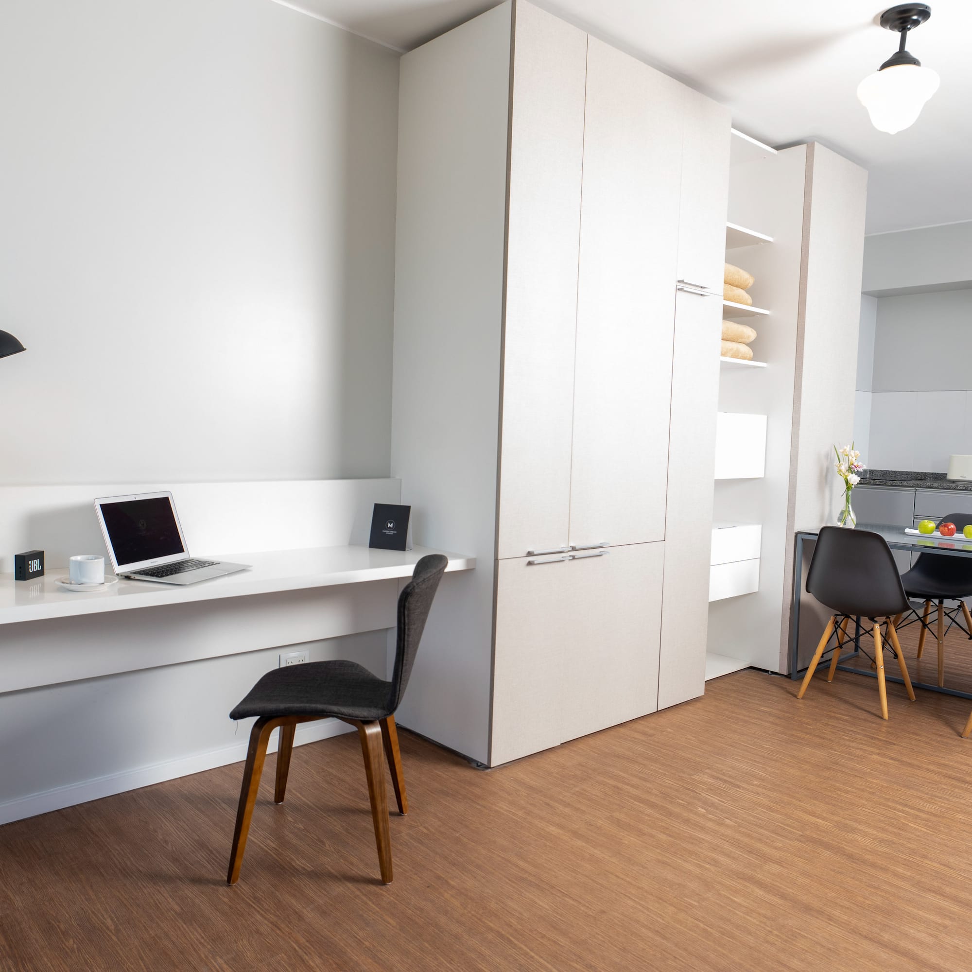 a room with a desk and a laptop