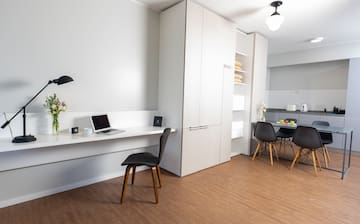 a room with a desk and a laptop