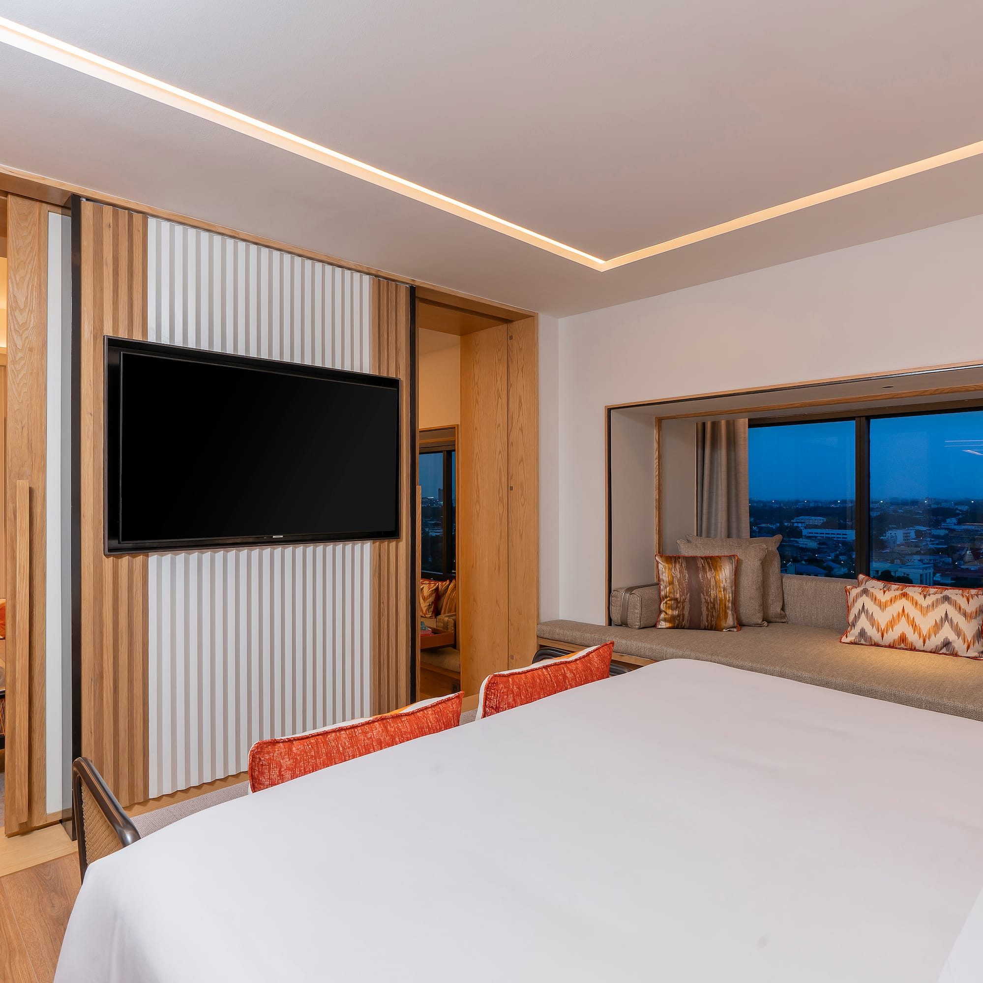 a room with a bed and a television