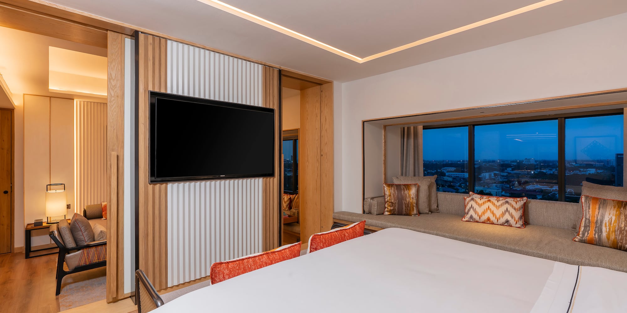 a room with a bed and a television