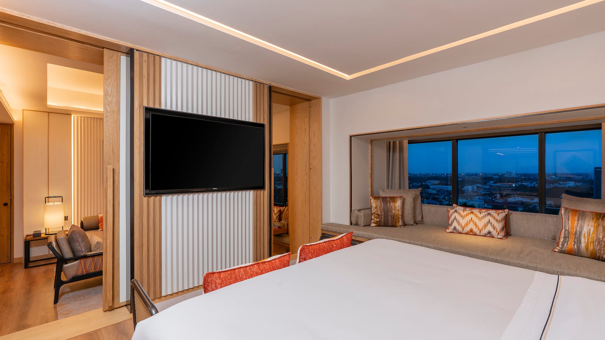 a room with a bed and a television