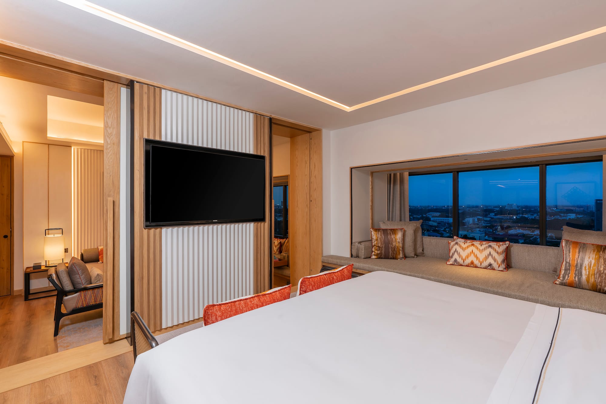 a room with a bed and a television