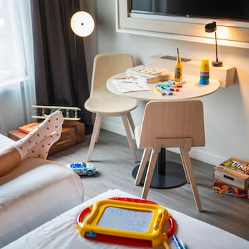 a room with a table and chairs and a table with toys