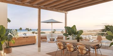 a patio with a table and chairs and a hot tub