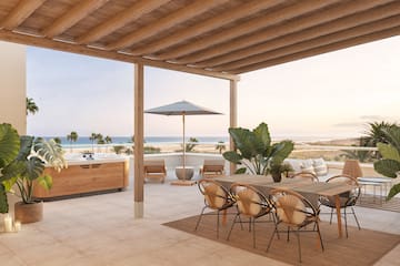 a patio with a table and chairs and a hot tub