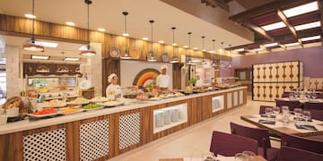 a restaurant with people in the kitchen