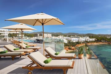 a deck with chairs and umbrellas on a sunny day