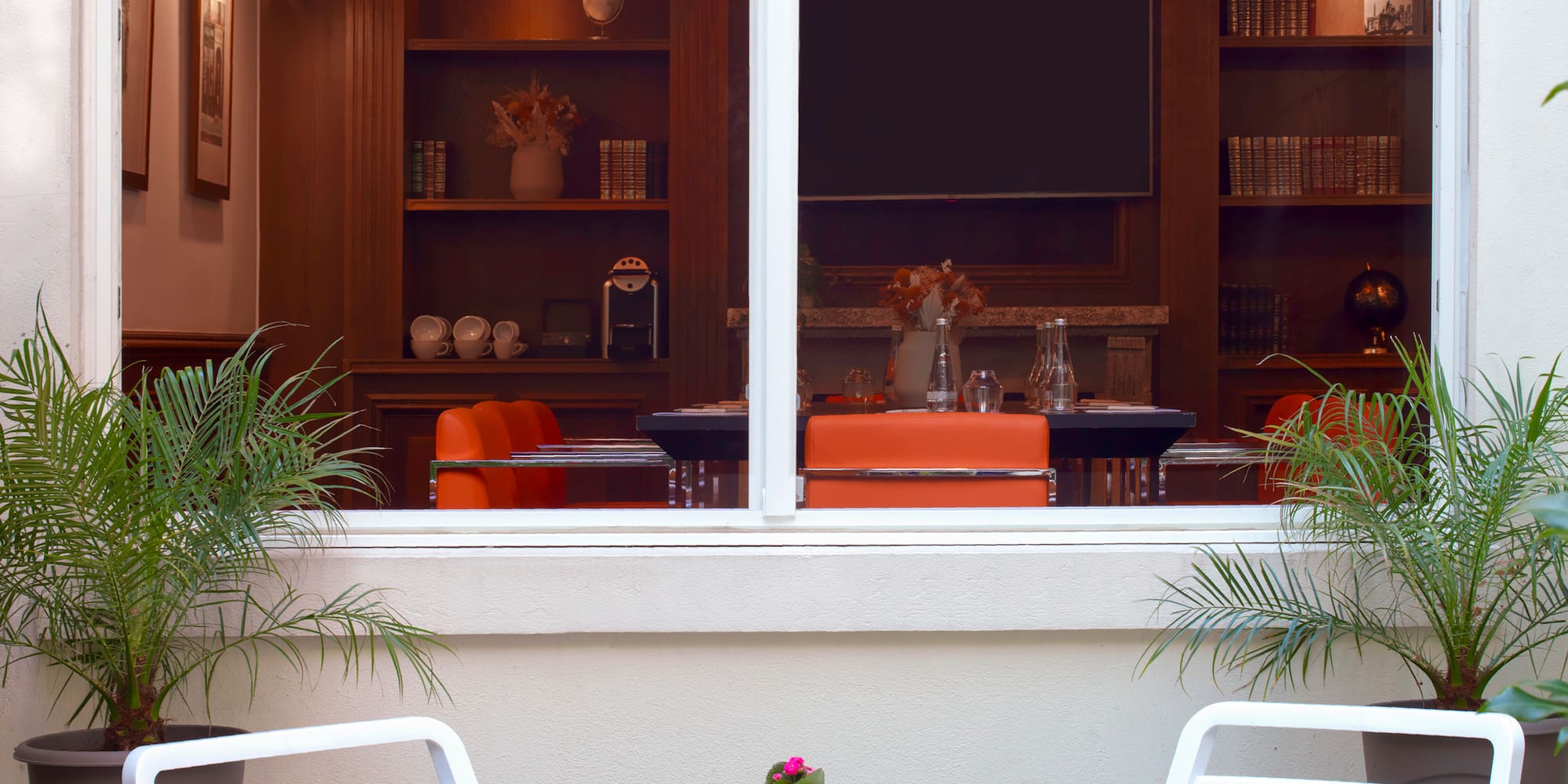 a table and chairs outside a window