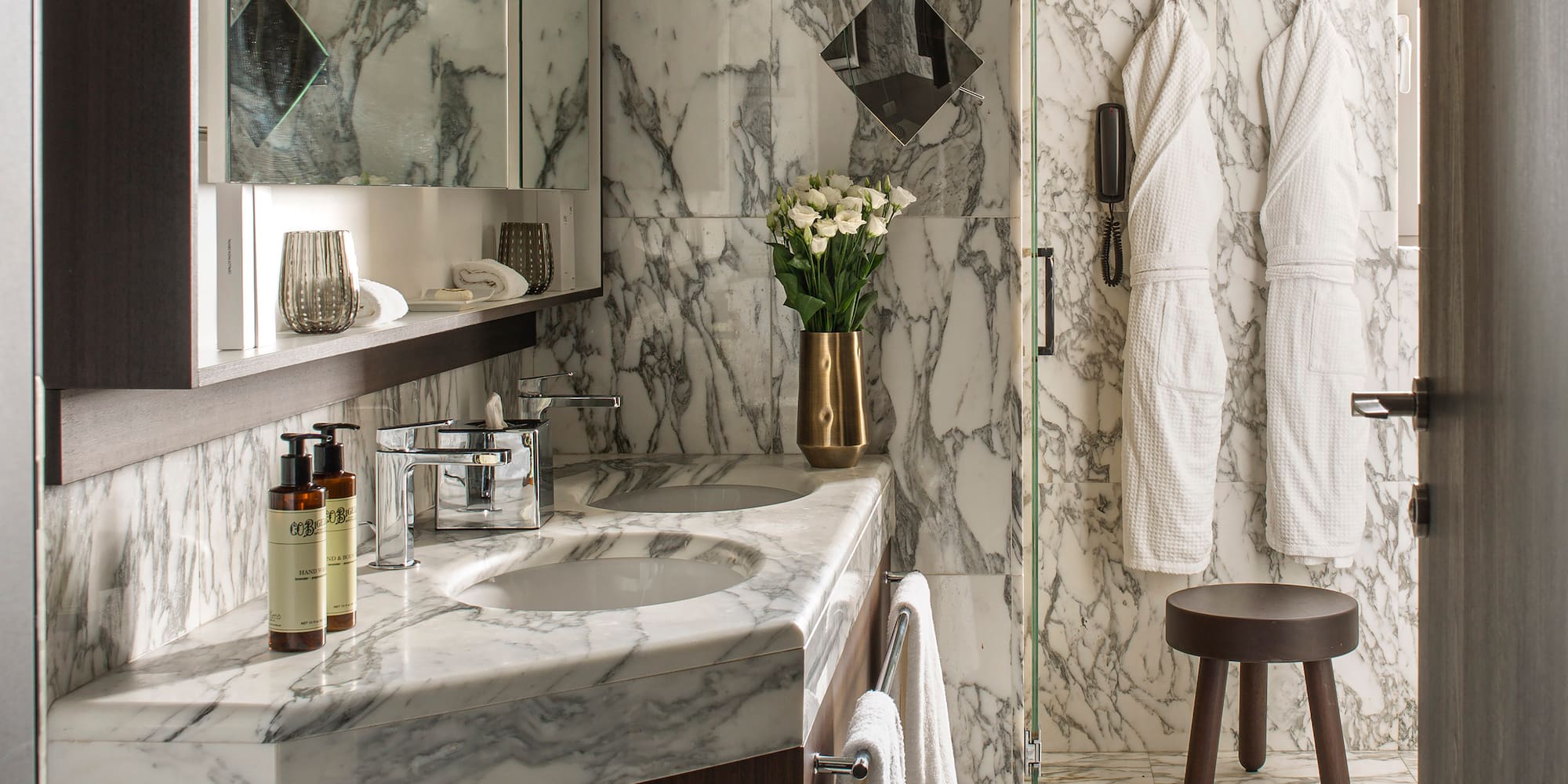 a bathroom with marble countertop and white towels