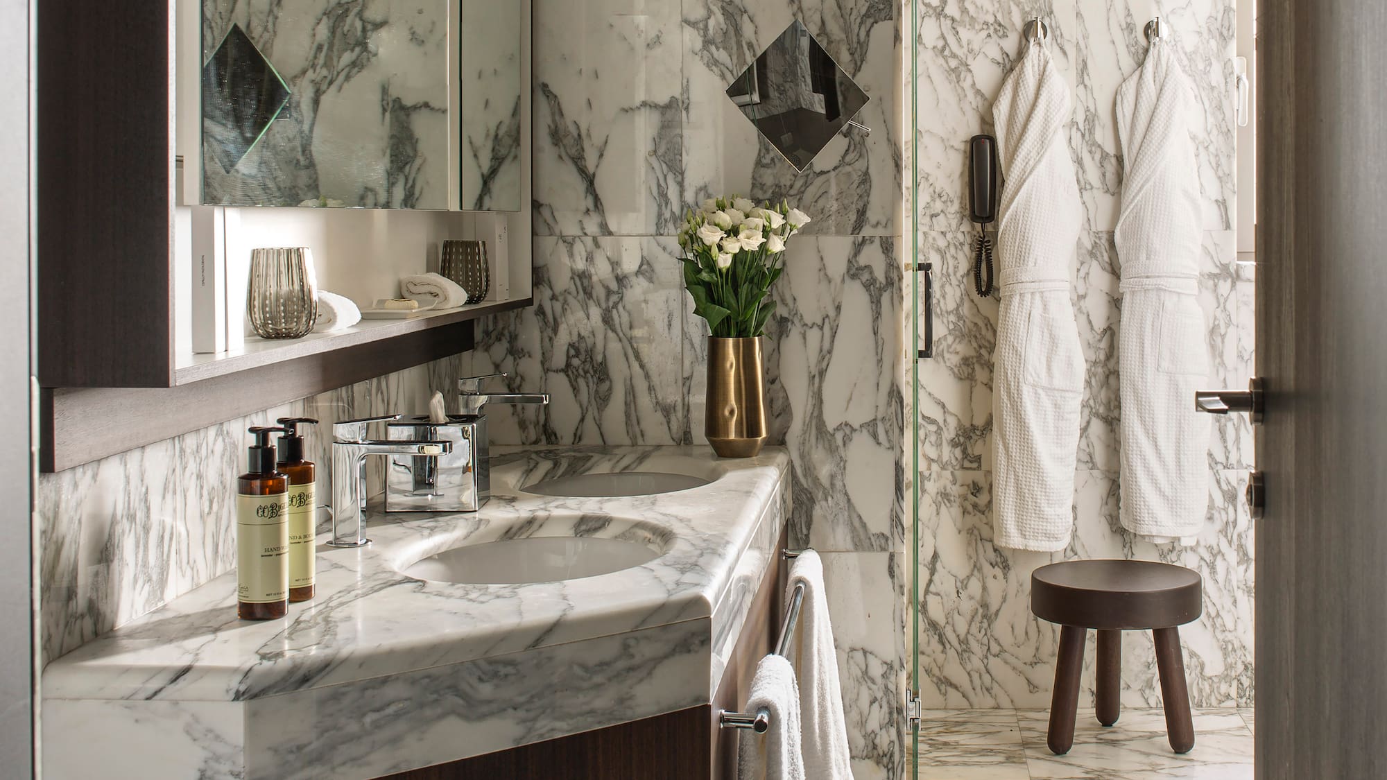 a bathroom with marble countertop and white towels