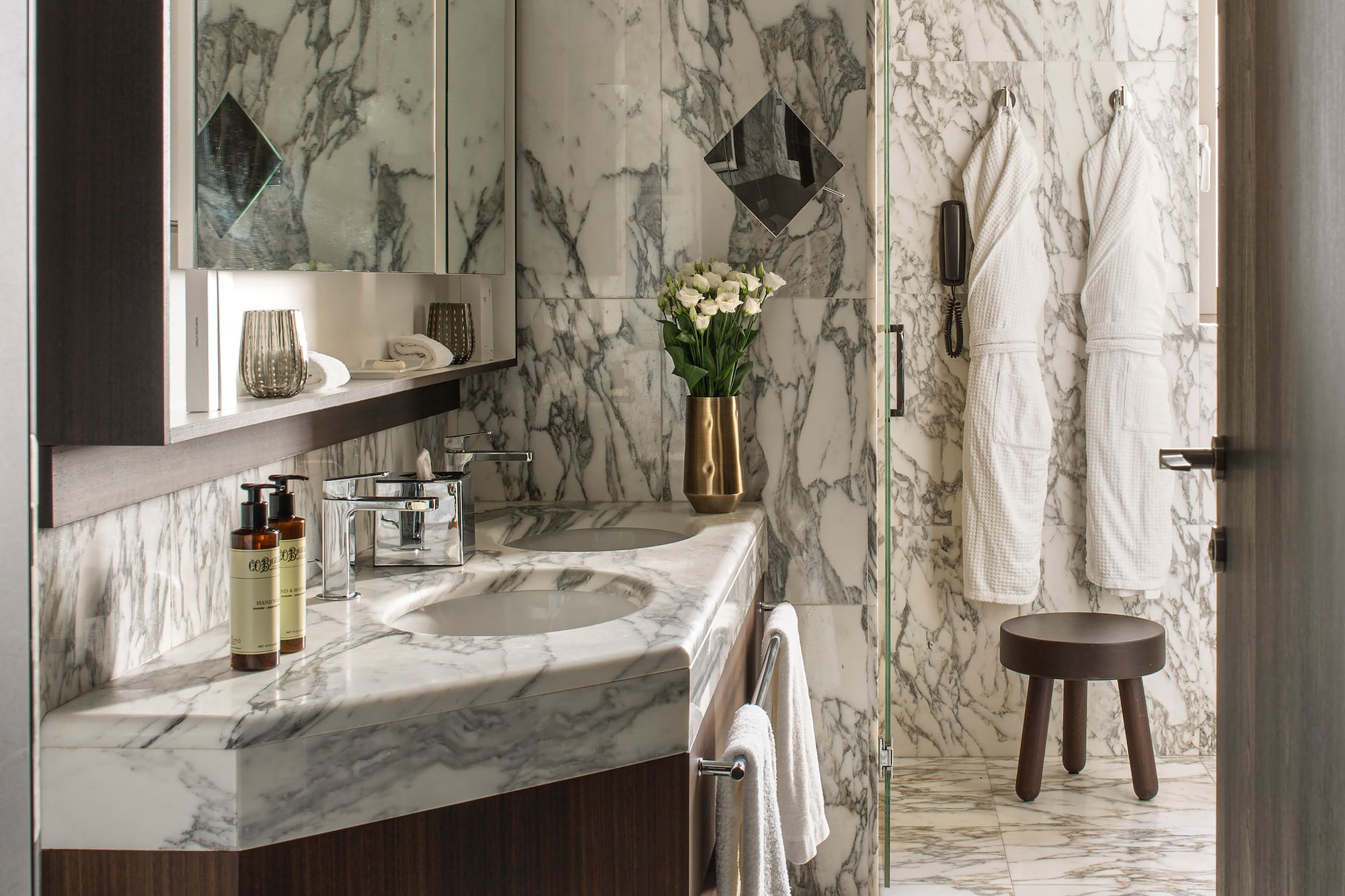 a bathroom with marble countertop and white towels