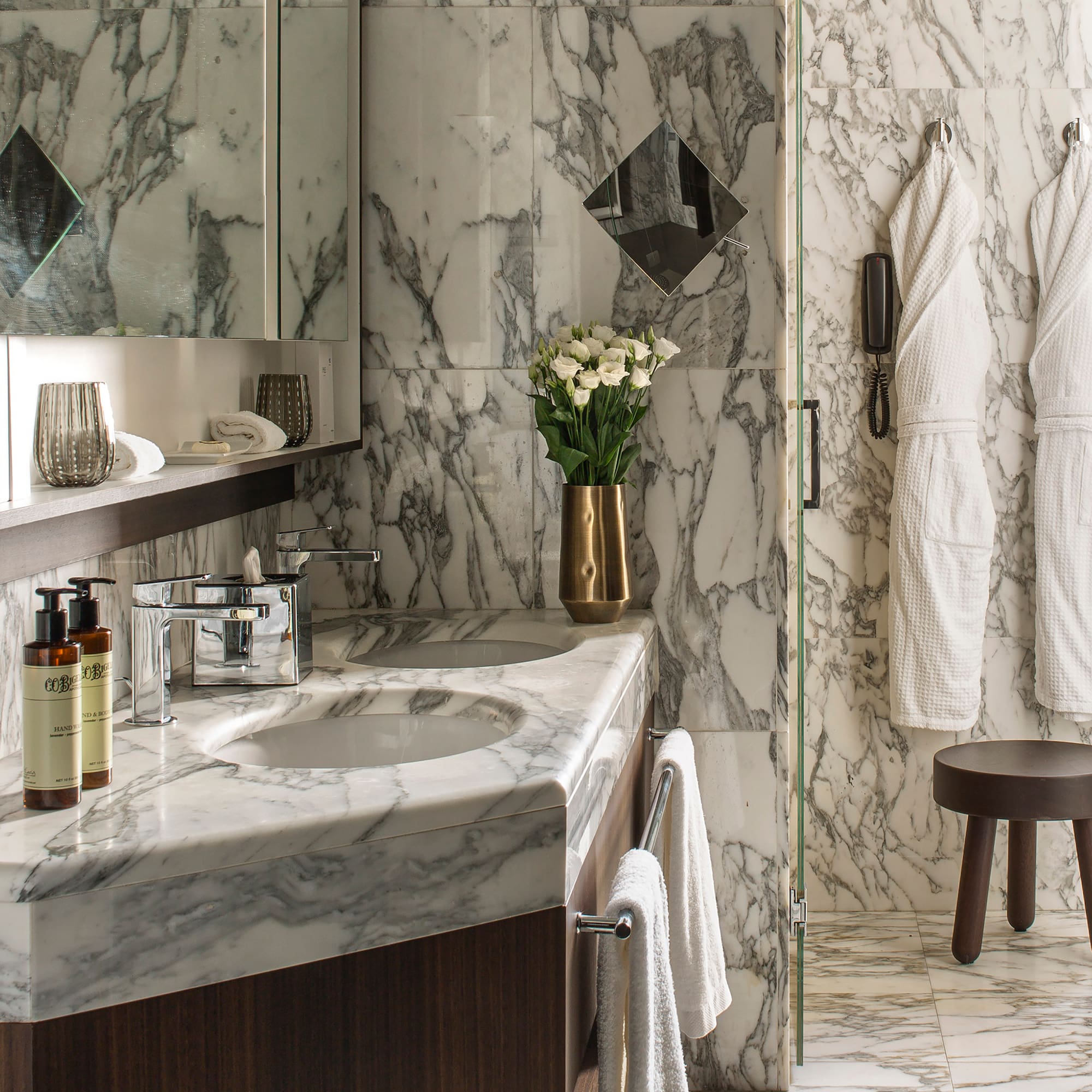 a bathroom with marble countertop and white towels