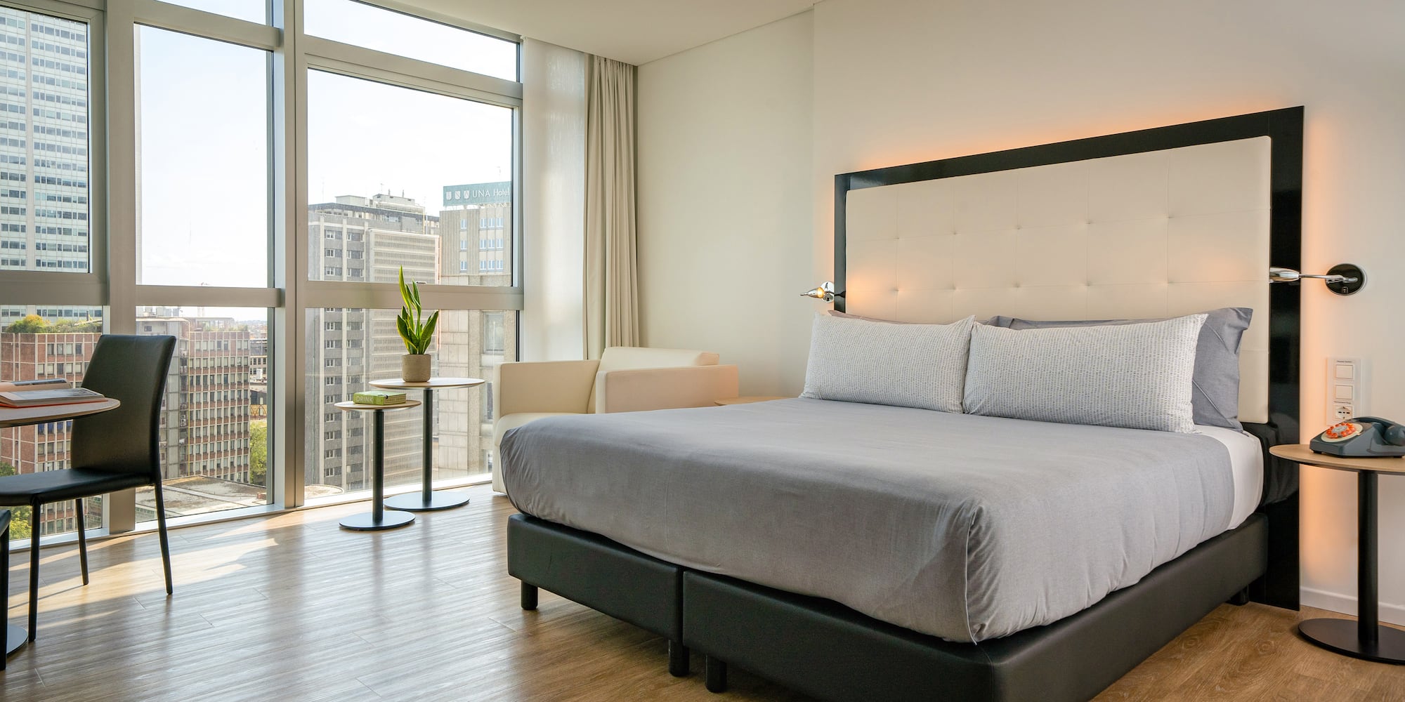 a bed in a room with large windows