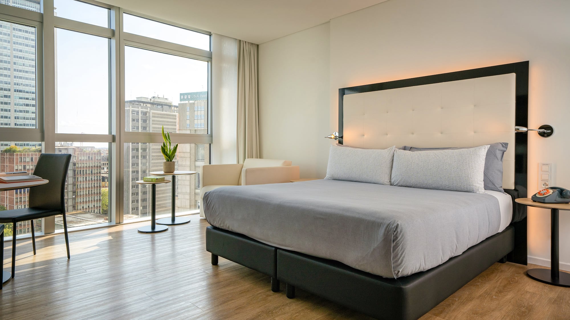 a bed in a room with large windows