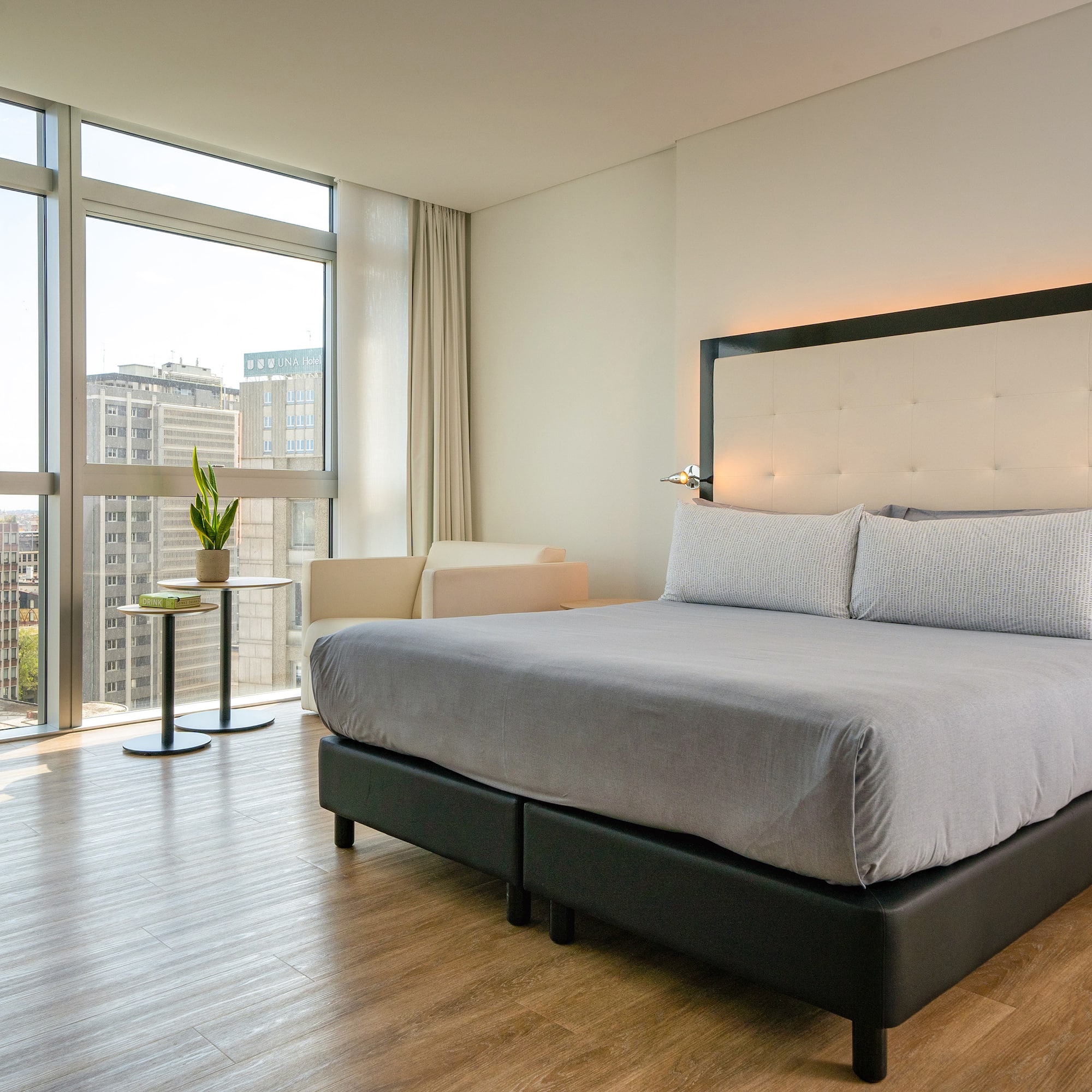 a bed in a room with large windows