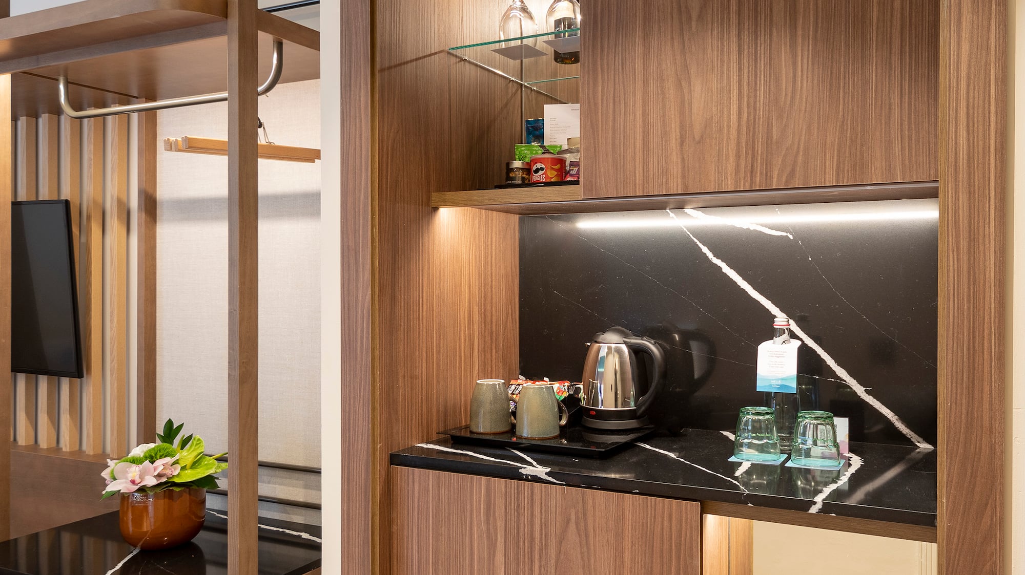 a room with a coffee bar and a table