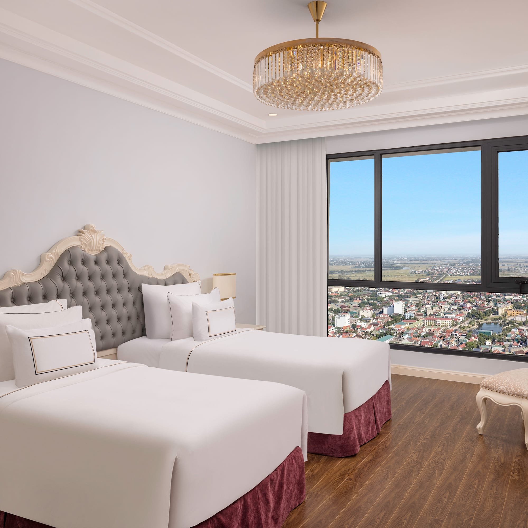 a room with two beds and a large window