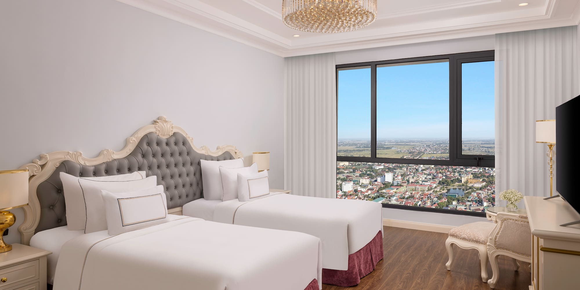 a room with two beds and a large window