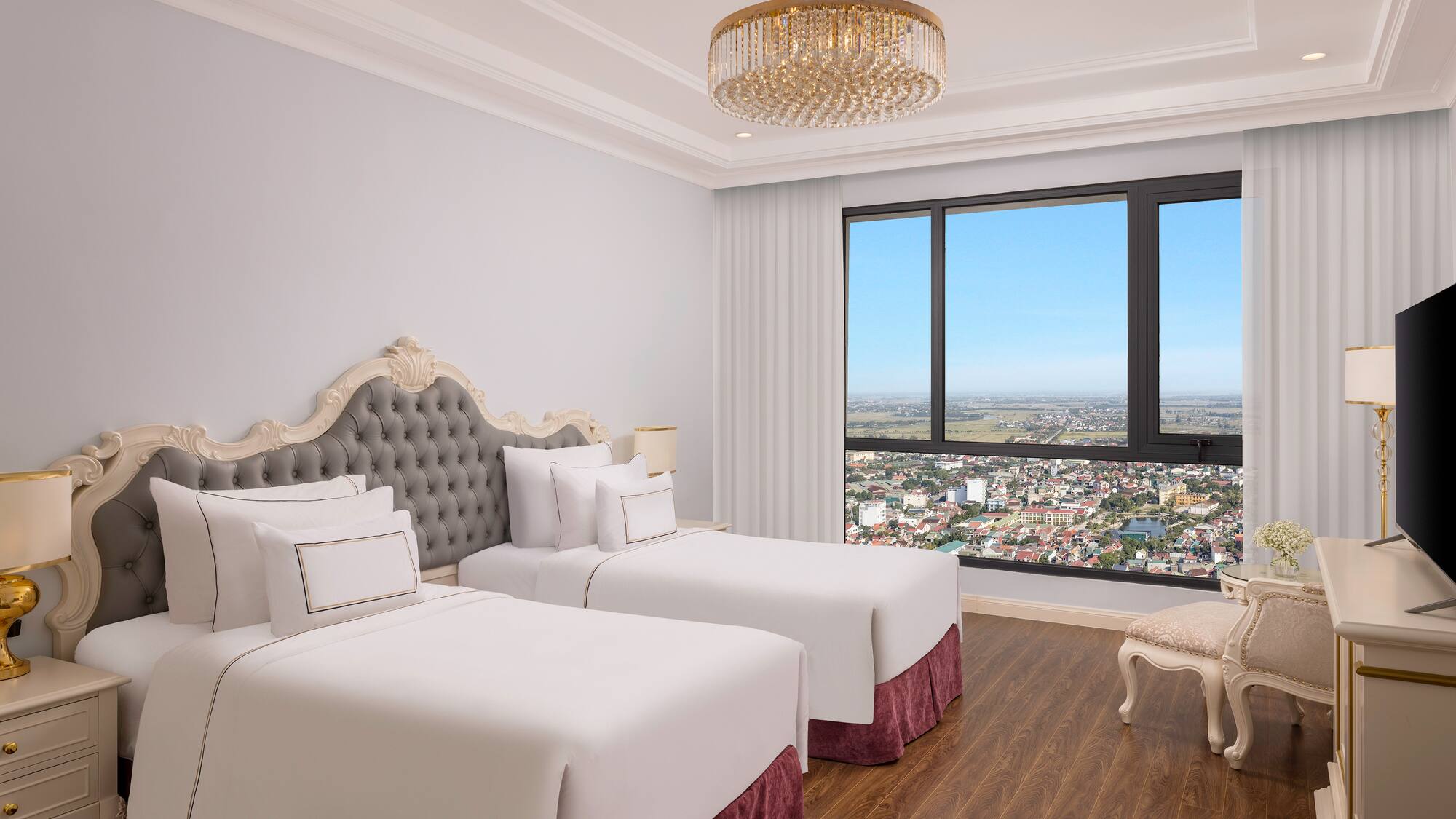 a room with two beds and a large window