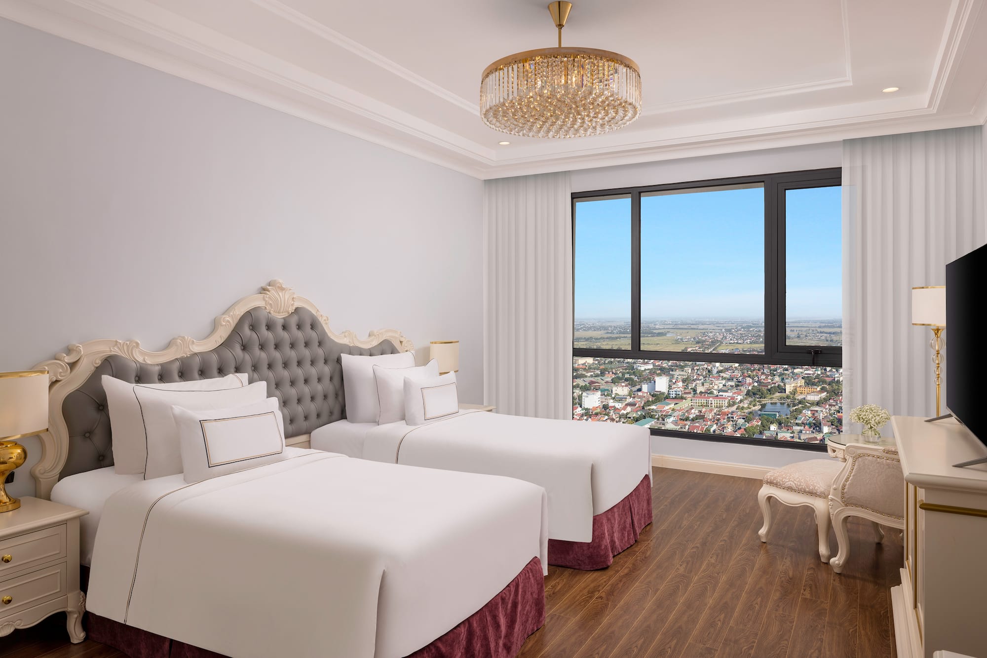 a room with two beds and a large window