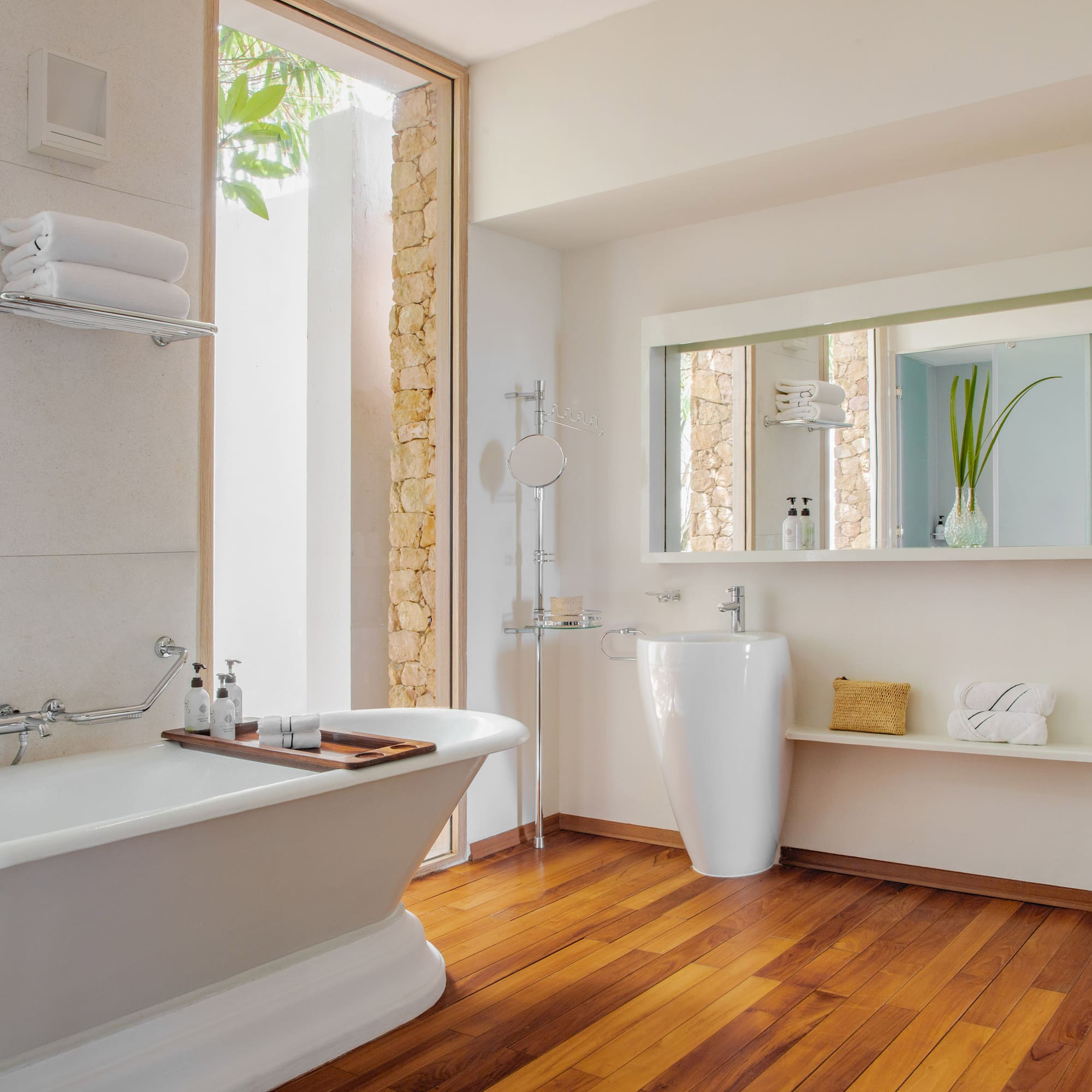 a bathroom with a bathtub and a mirror