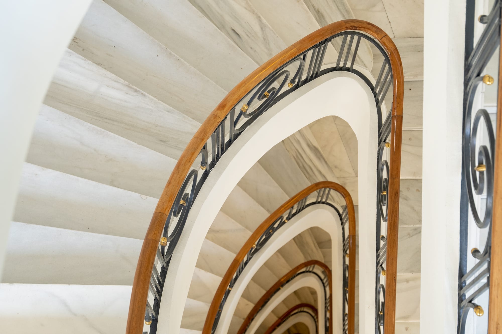 a spiral staircase with a black railing