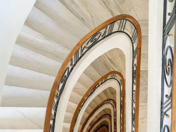 a spiral staircase with a black railing