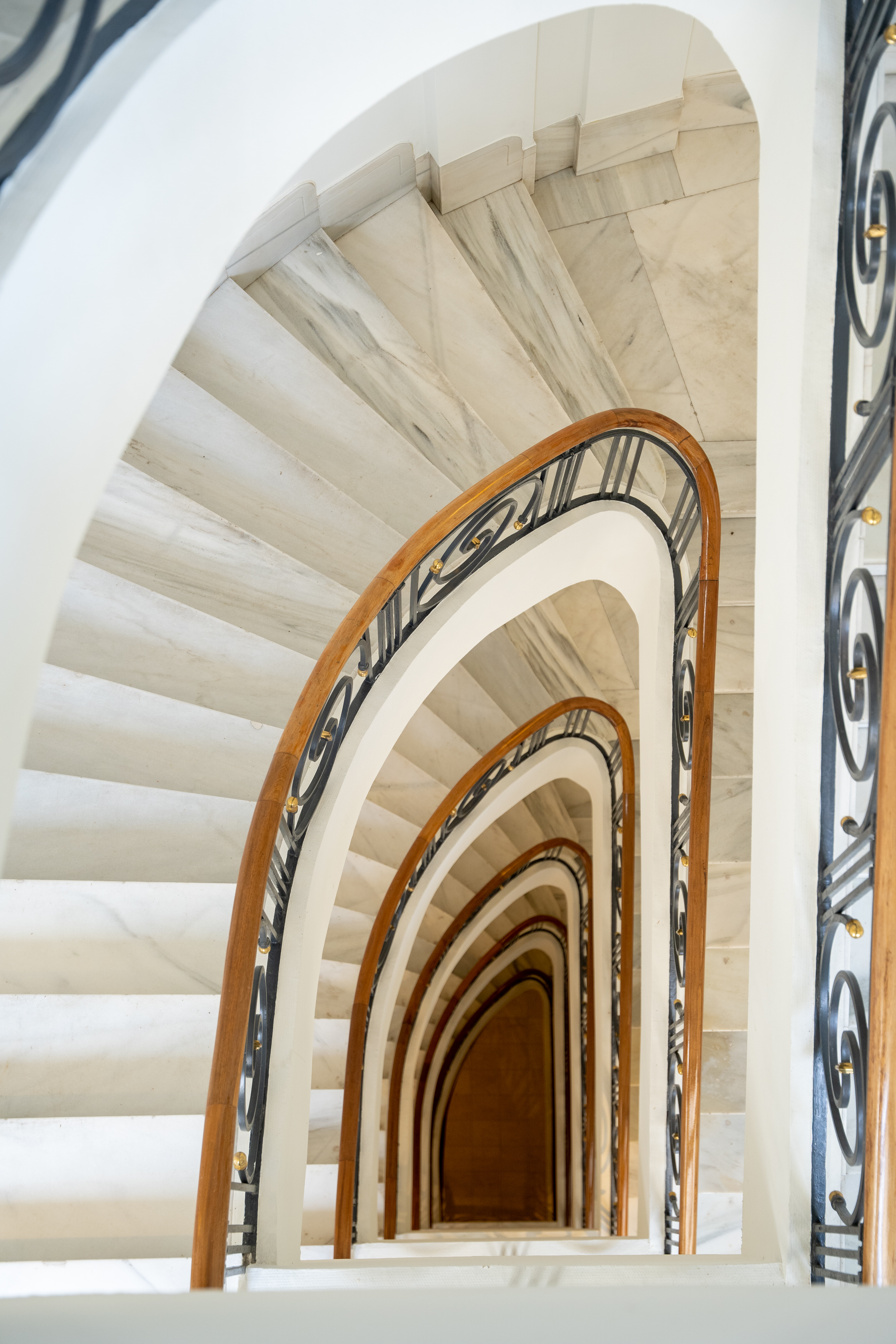 a spiral staircase with a black railing