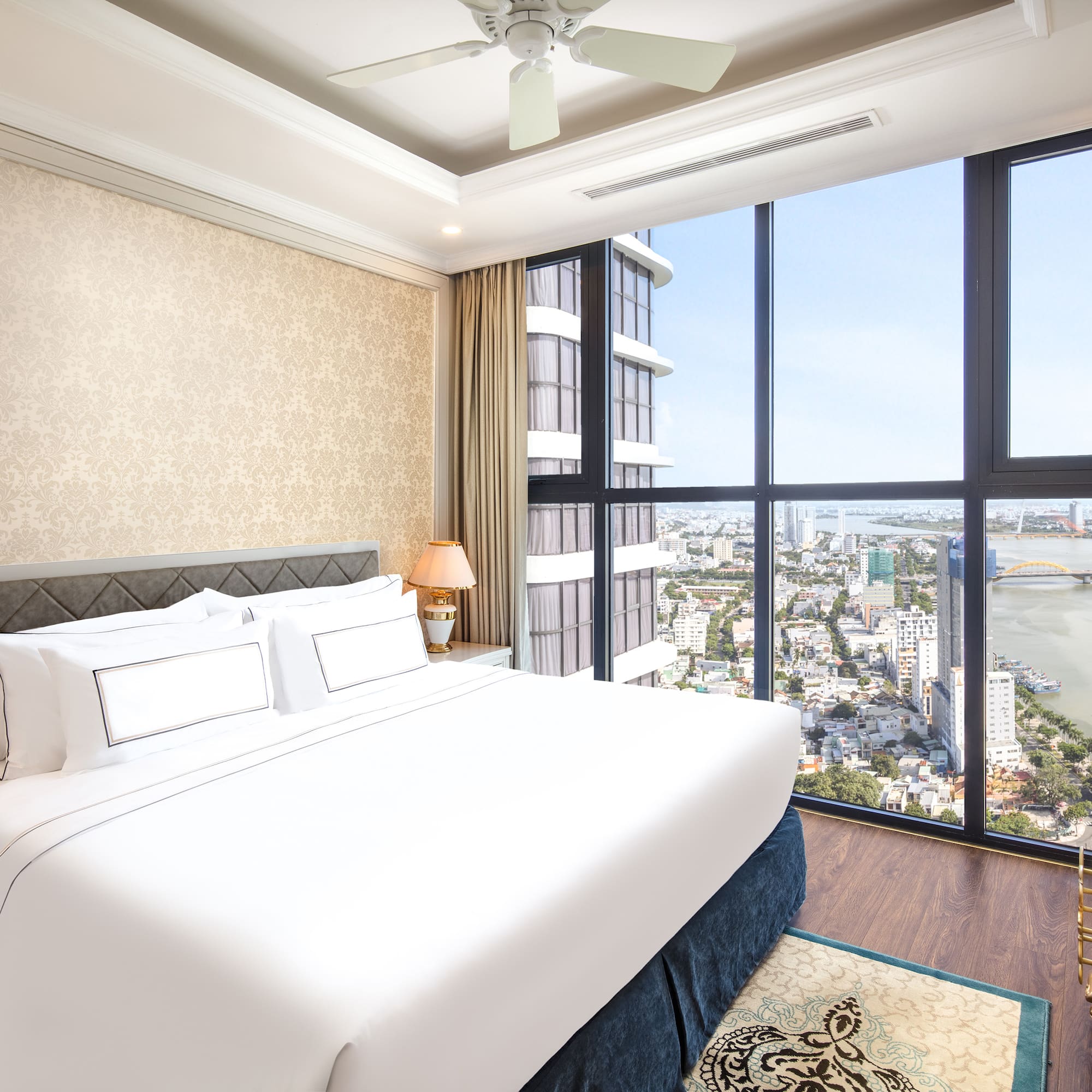 a bedroom with a large window overlooking a city