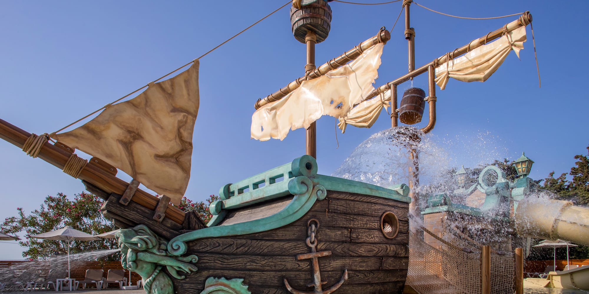 a water park with a ship and a water slide