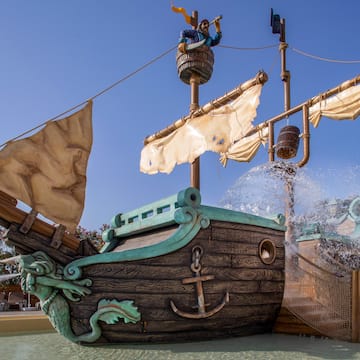 a water park with a ship and a water slide