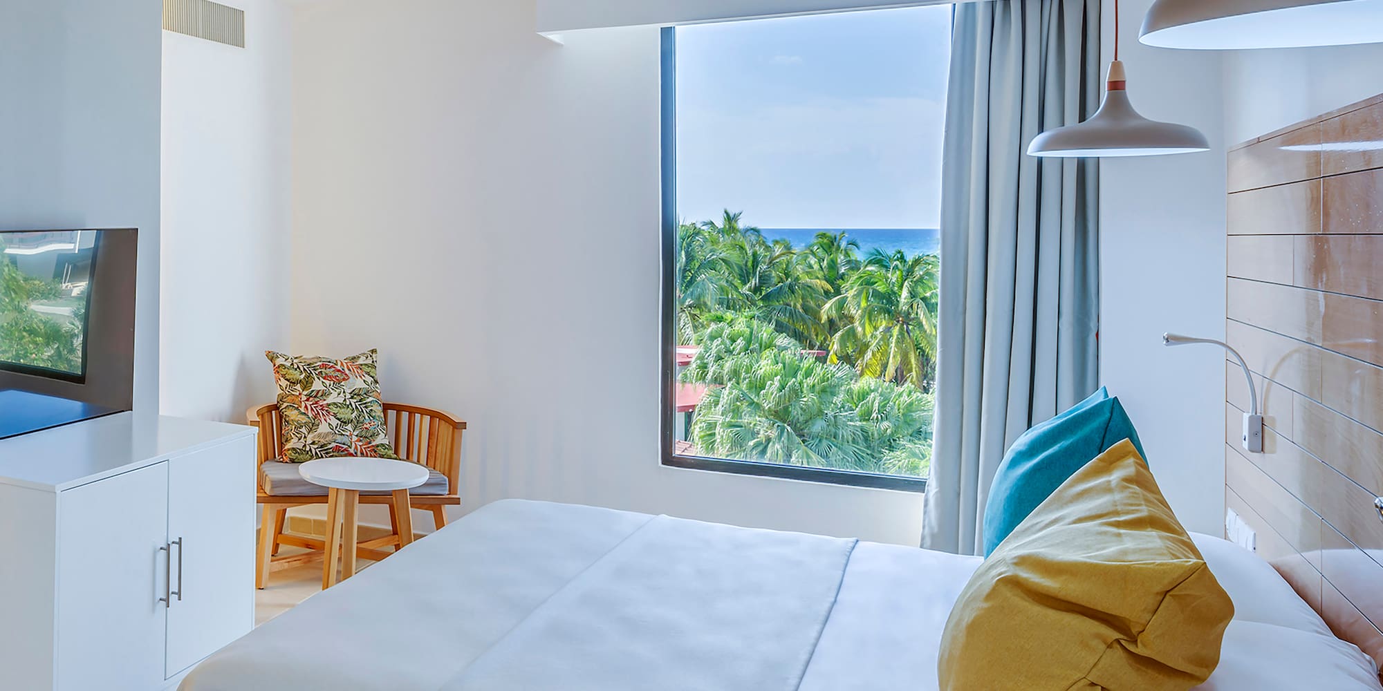 a bedroom with a large window and a bed