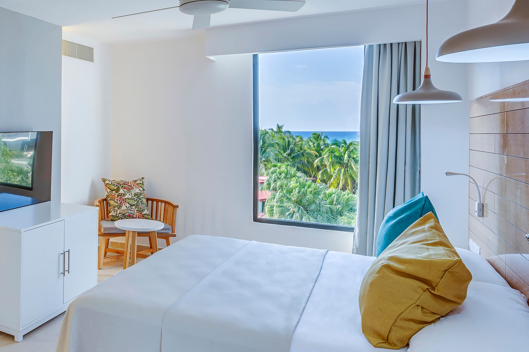 a bedroom with a large window and a bed