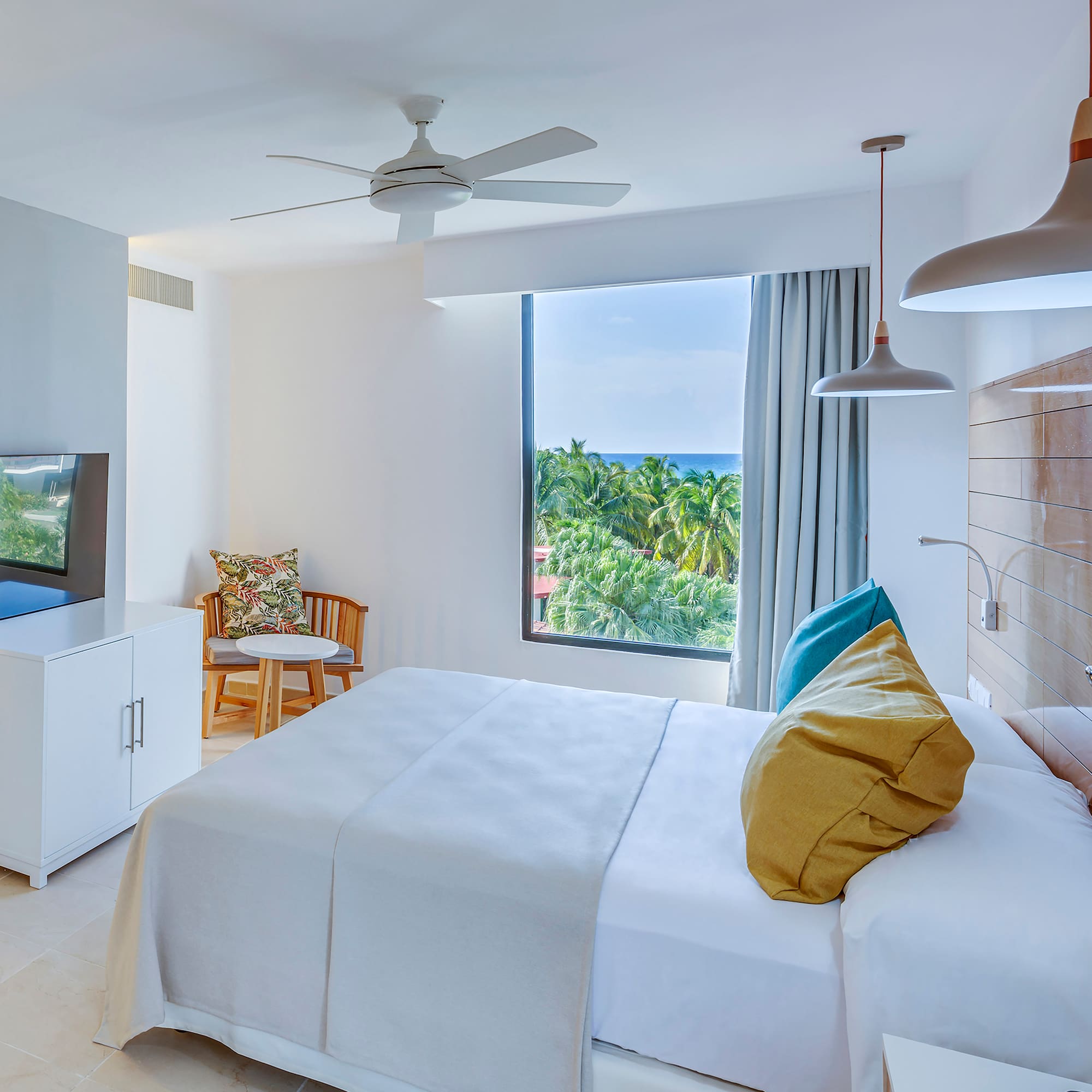 a bedroom with a large window and a bed