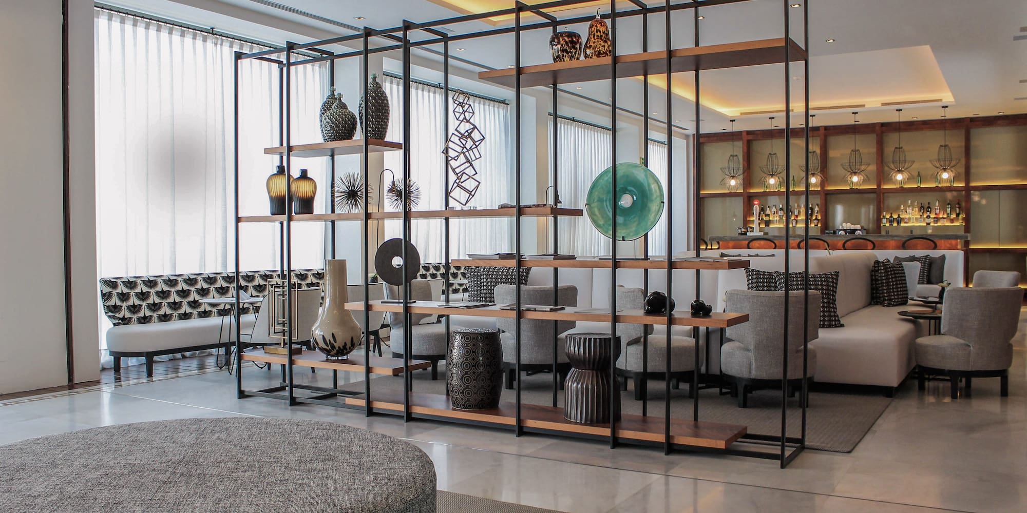 a room with a large metal structure with shelves and chairs