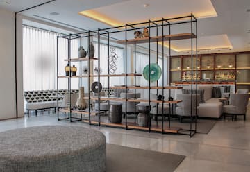 a room with a large metal structure with shelves and chairs