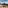 Hotel balcony with lounge chairs, refreshing drinks, fruit, and scenic ocean view.