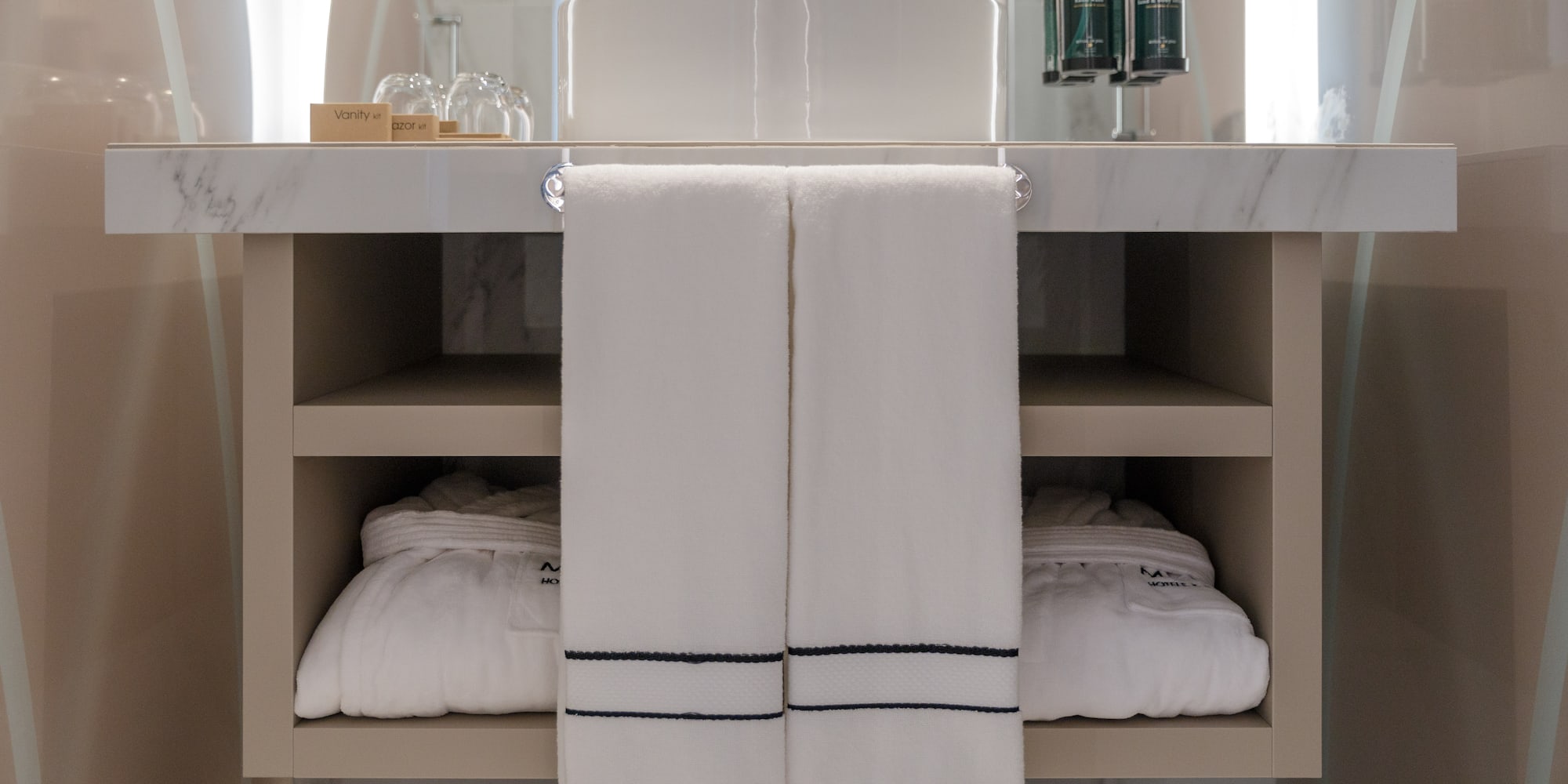 a bathroom sink with white towels