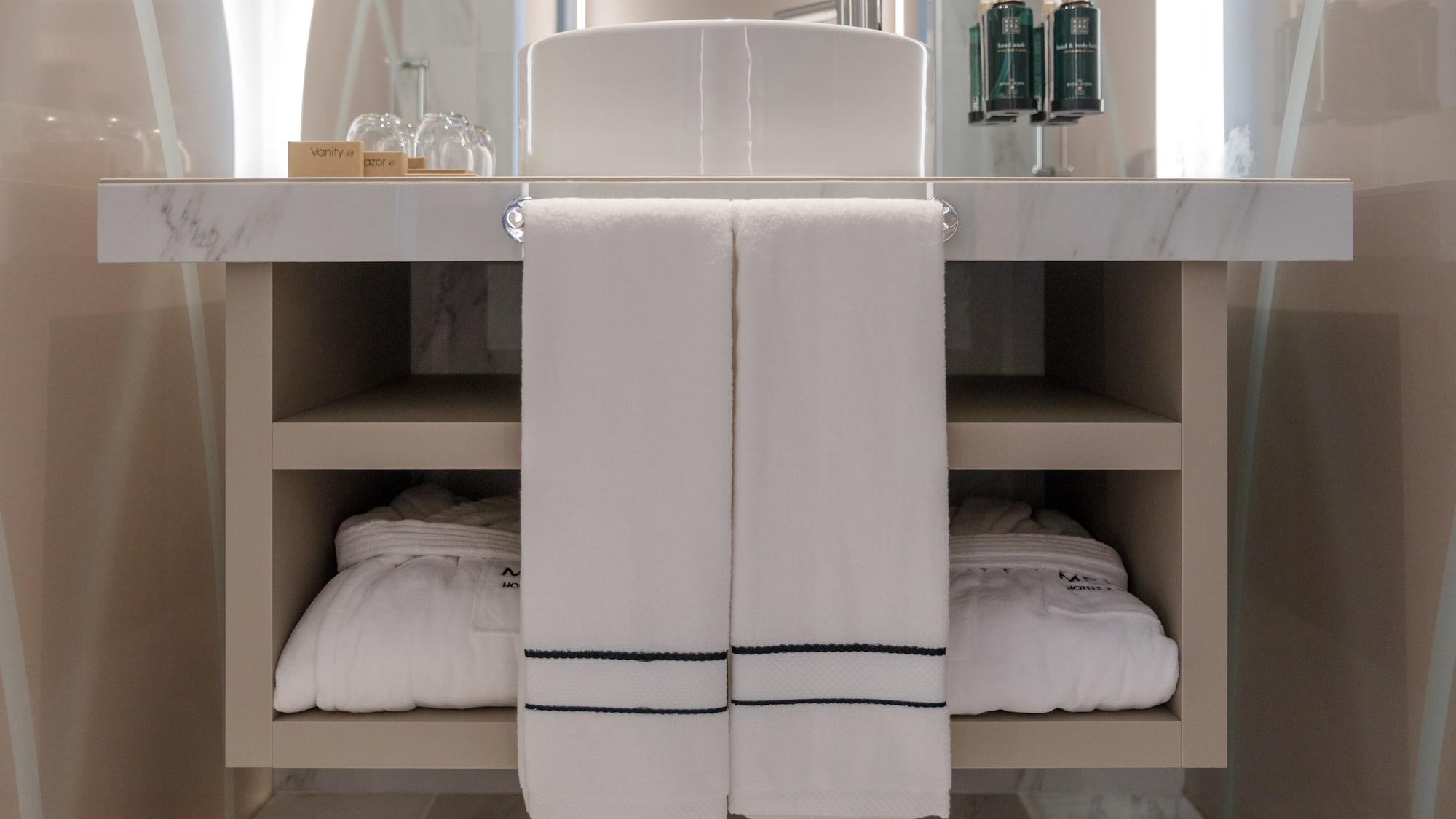 a bathroom sink with white towels