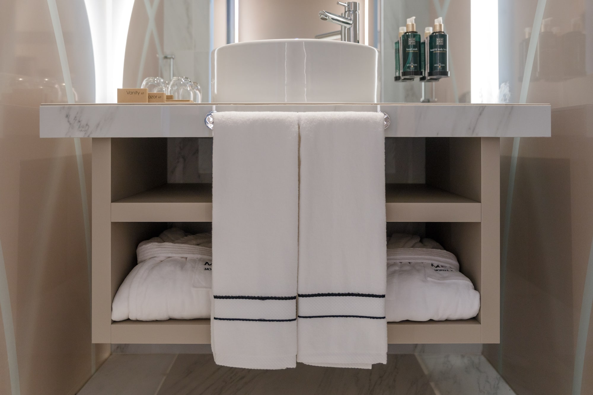 a bathroom sink with white towels