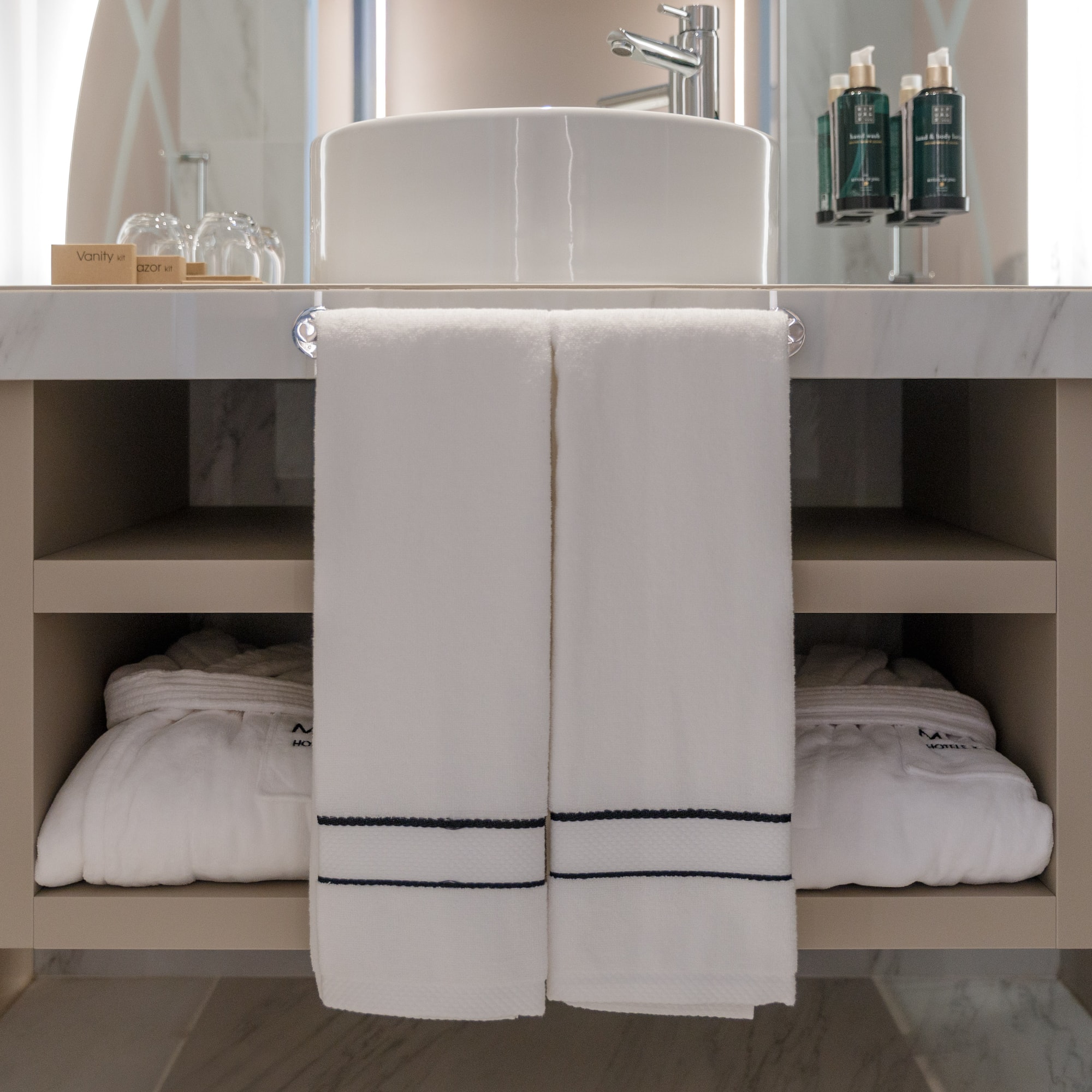 a bathroom sink with white towels