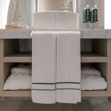 a bathroom sink with white towels