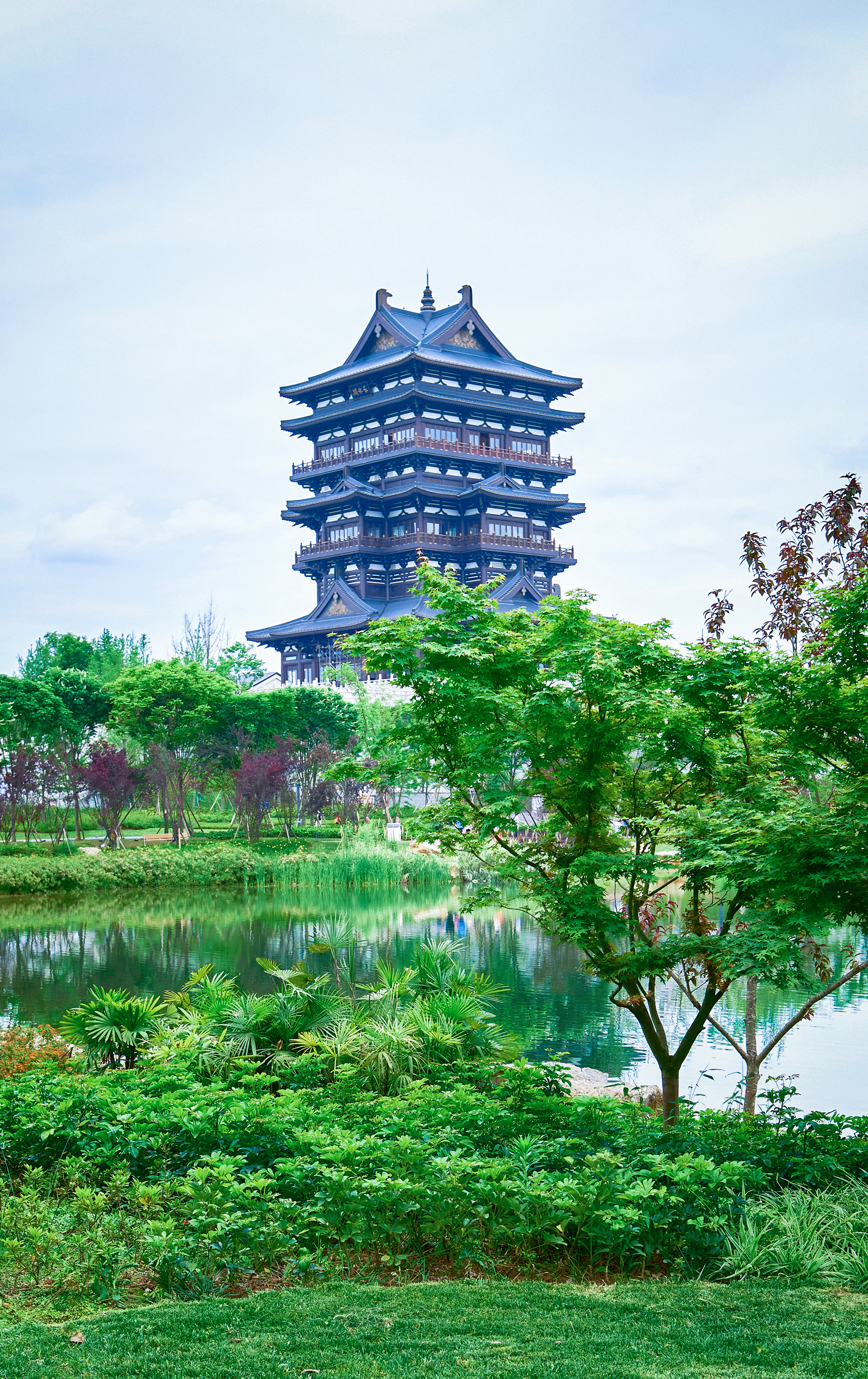 Himeji Castle with a pond and trees