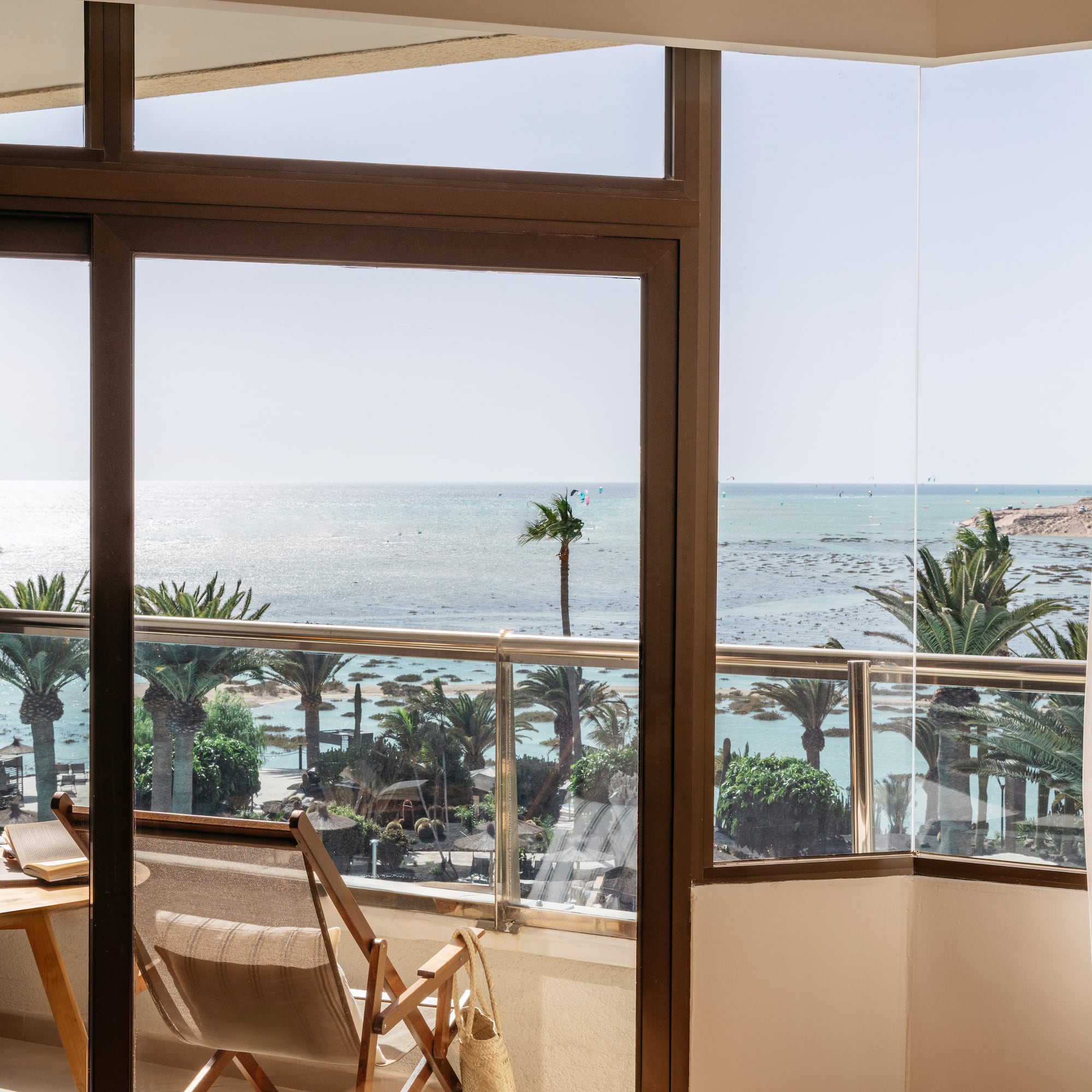a room with a view of the ocean and a beach
