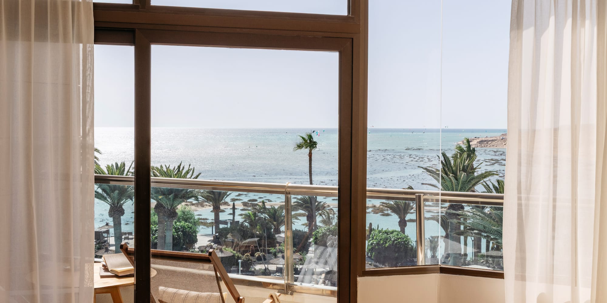 a room with a view of the ocean and a beach