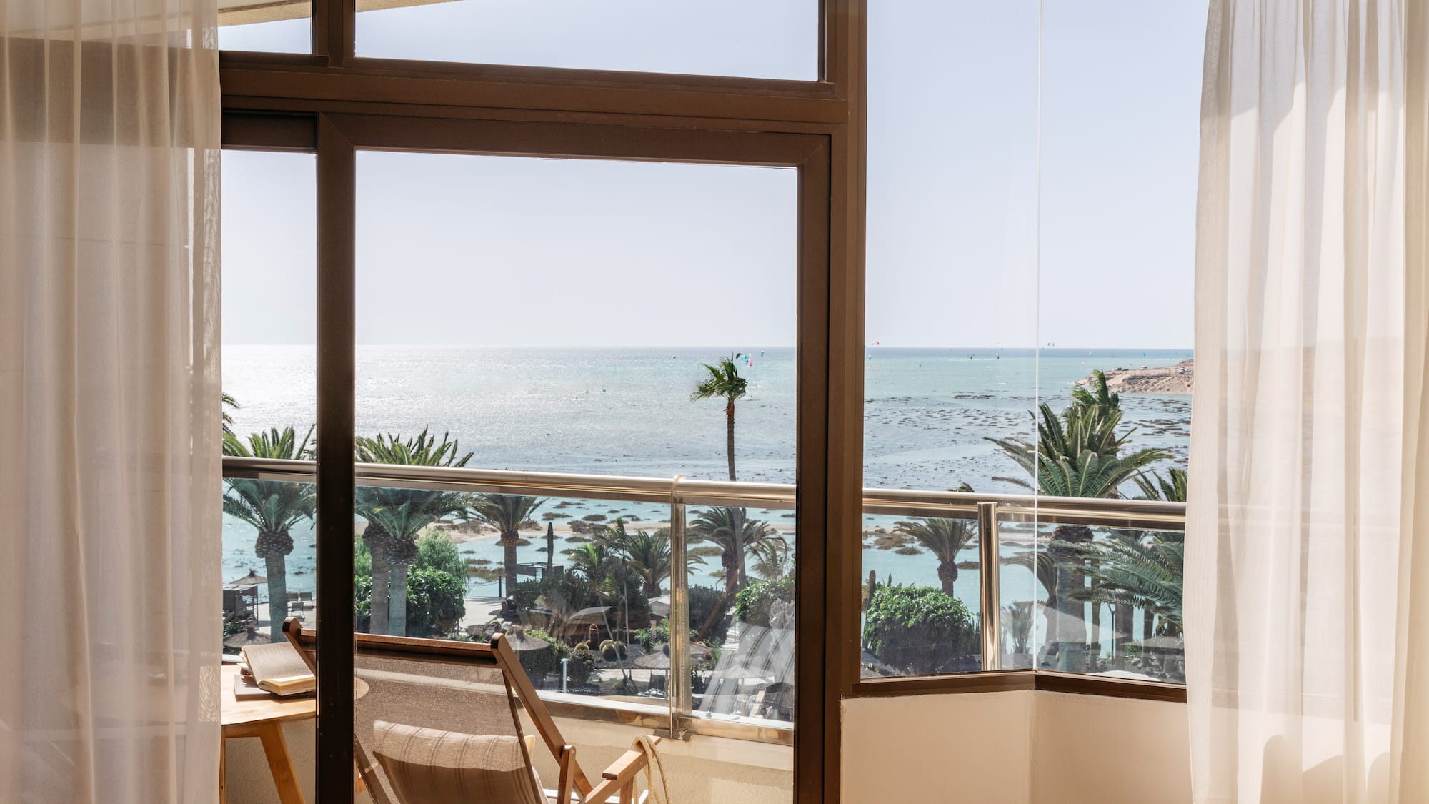 a room with a view of the ocean and a beach