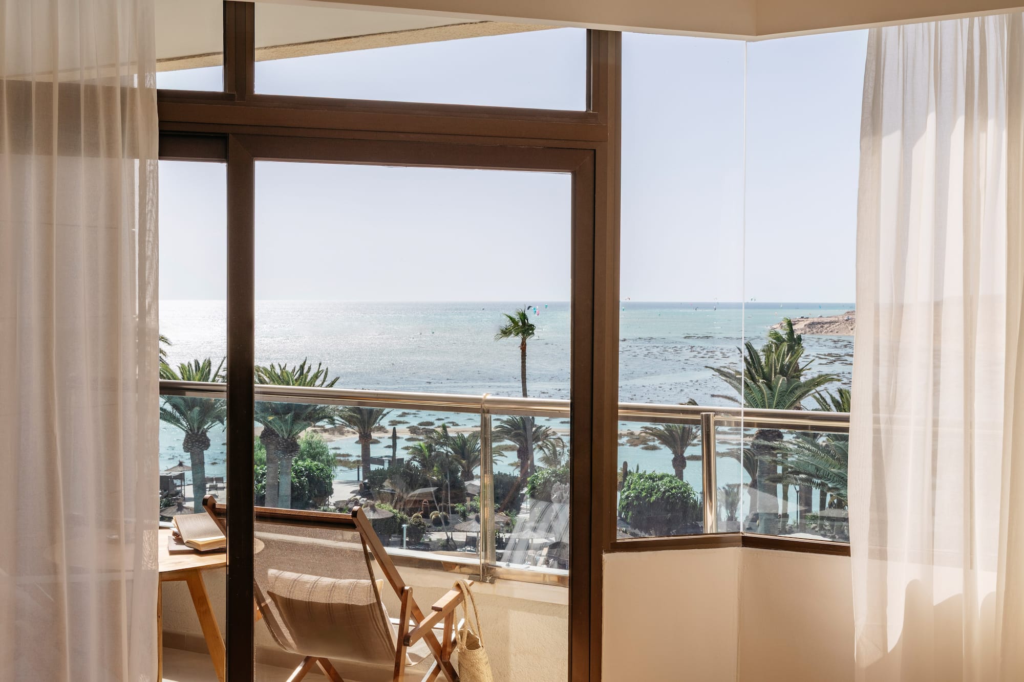 a room with a view of the ocean and a beach