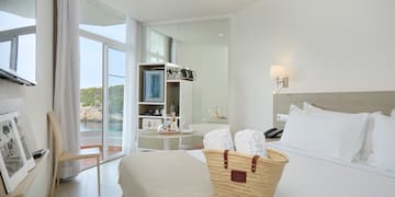 a basket of towels on a bed in a hotel room