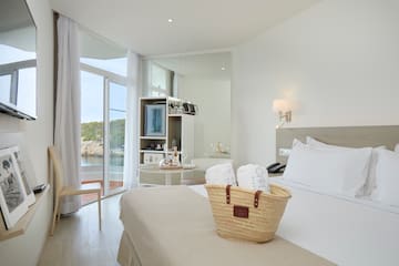 a basket of towels on a bed in a hotel room